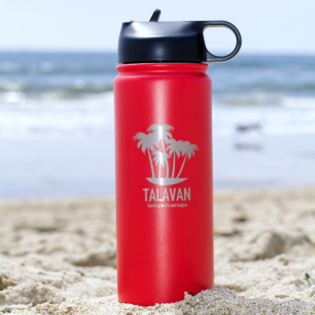 Red 18 oz thermos on beach