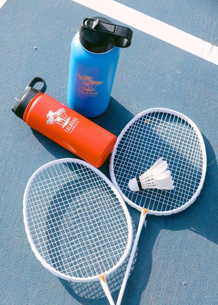Sports- Chelsea Loren TalavanLLC Thermos Water Bottle Product Photography 39 - 18oz Red and 32oz Blue thermos with Badminton rackets 